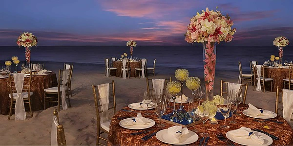 Beach reception setup with elegant tables at Secrets Royal Beach Punta Cana