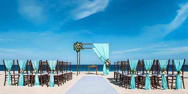 Beach wedding ceremony setup with turquoise décor at Secrets Royal Beach Punta Cana