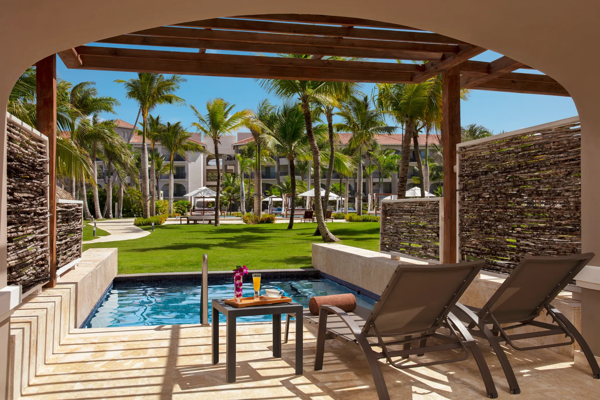Junior Suite Private Pool terrace with plunge pool and lounge chairs at Secrets Royal Beach Punta Cana.