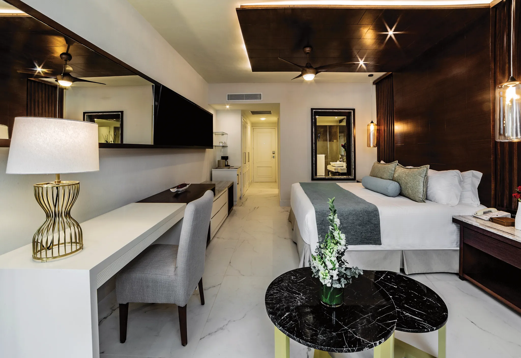 Junior Suite Tropical View with king bed and modern workspace at Secrets Royal Beach Punta Cana.