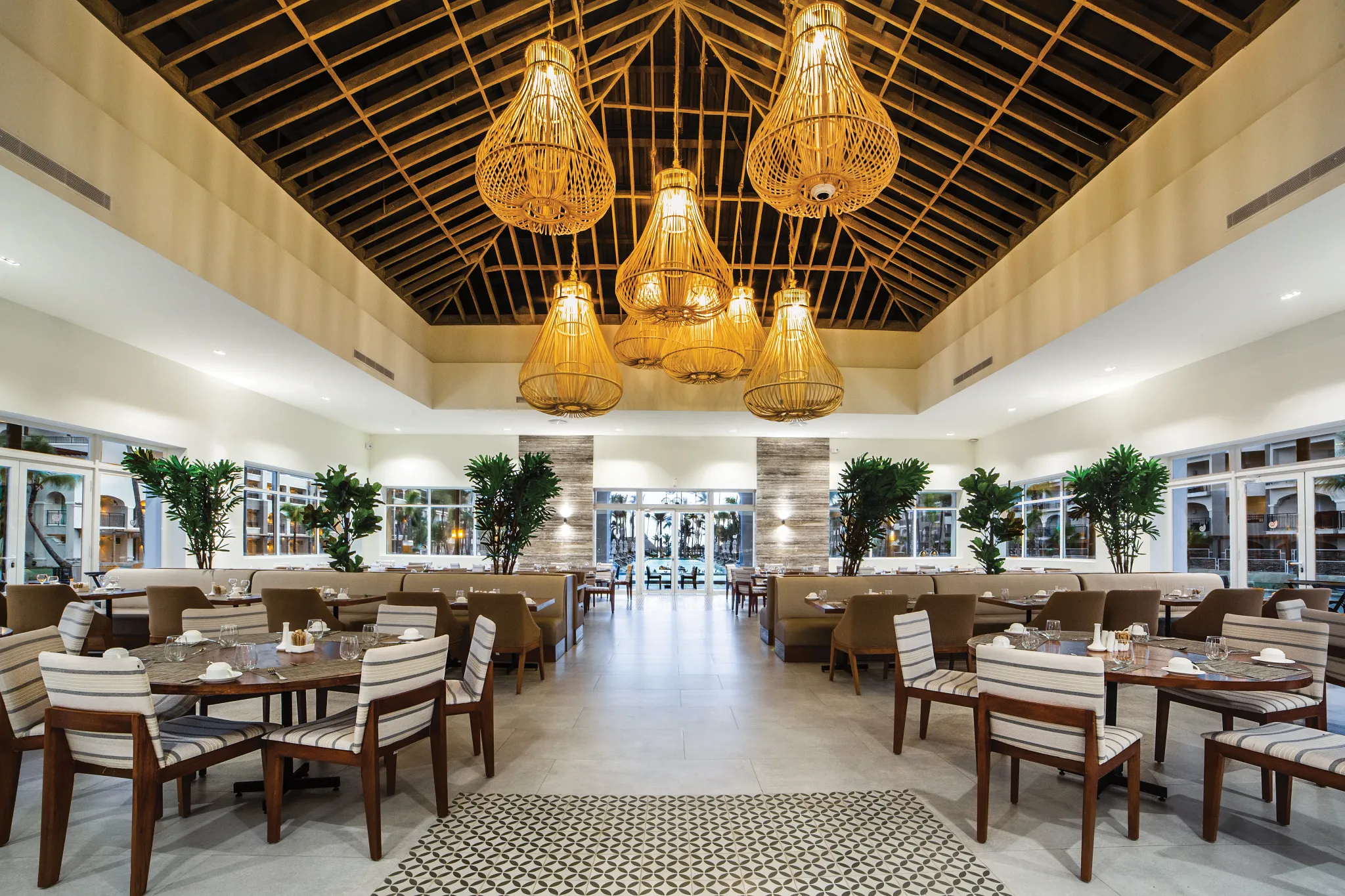 La Riviera International Buffet at Secrets Royal Beach Punta Cana featuring a spacious dining hall with tropical décor and elegant lighting.