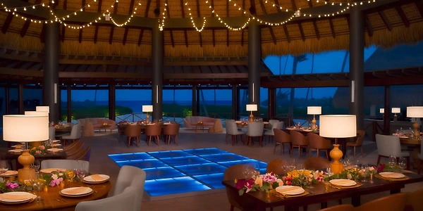 Olio Restaurant reception setup with illuminated dance floor at Secrets Royal Beach Punta Cana
