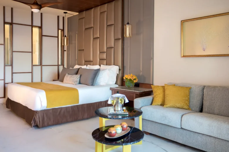 Preferred Club Junior Suite Pool View with king bed and seating area at Secrets Royal Beach Punta Cana.