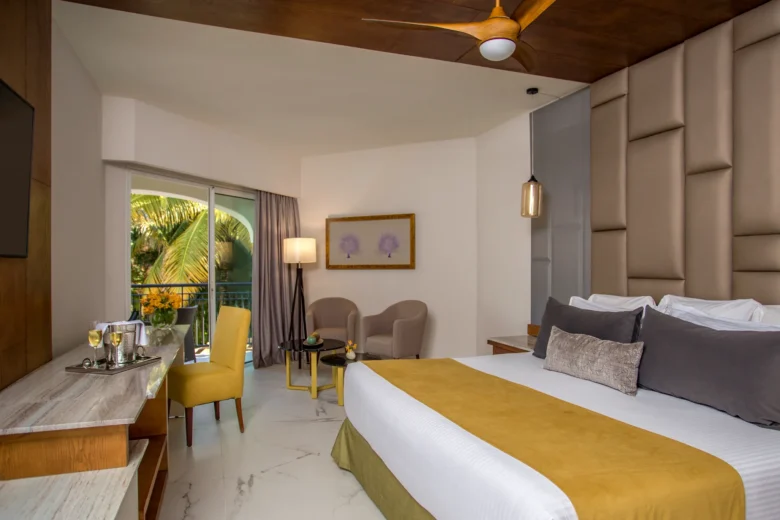 Preferred Club Junior Suite Tropical View with king bed and balcony access at Secrets Royal Beach Punta Cana.