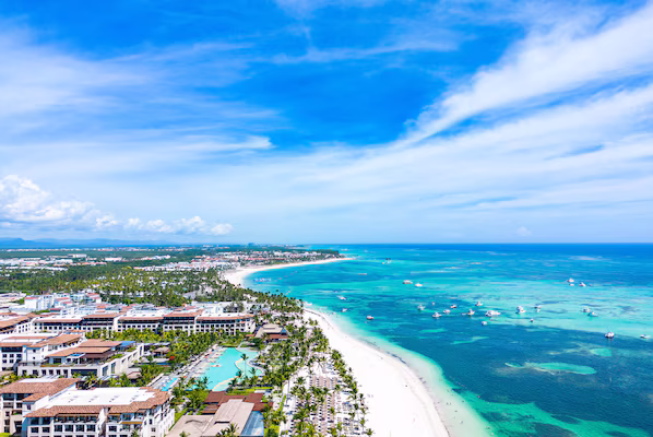 Punta Cana Beach near Secrets Royal Beach Punta Cana with palm-lined shoreline and turquoise Caribbean waters