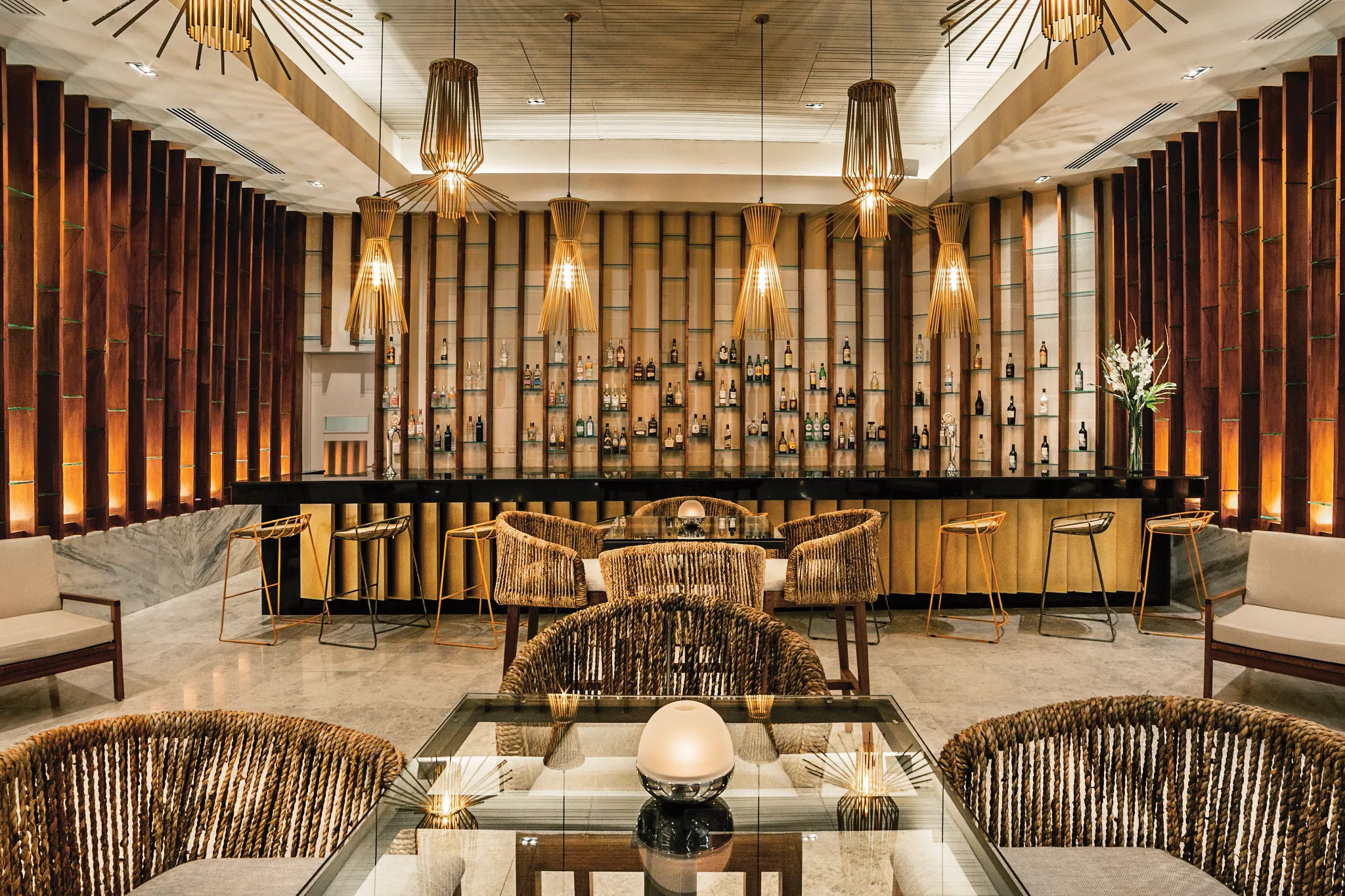 Rendezvous Lobby Bar at Secrets Royal Beach Punta Cana featuring elegant lounge seating, modern lighting, and a stylish cocktail bar.