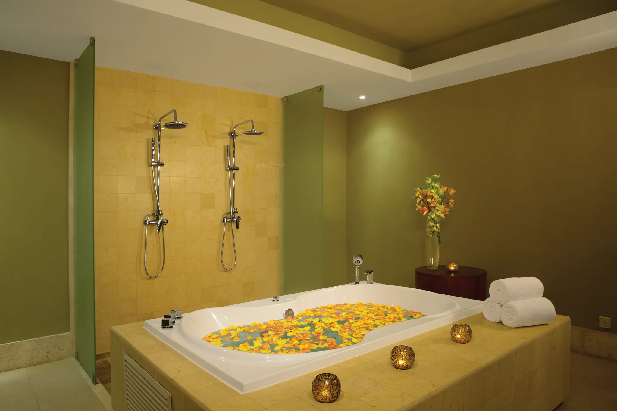 Romantic spa bathtub filled with flower petals inside a VIP spa cabin at Secrets Royal Beach Punta Cana.