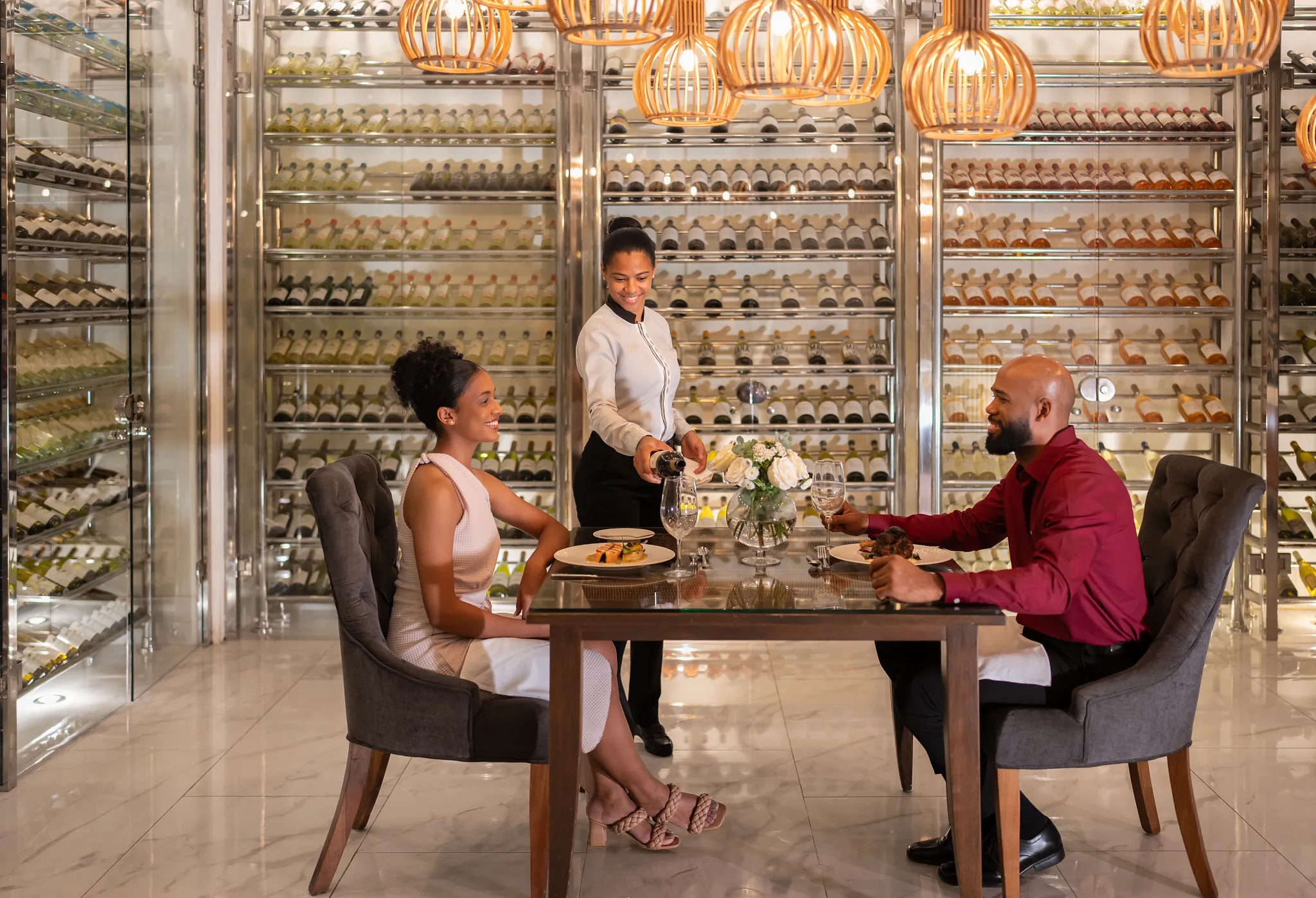Couple enjoying a private wine cellar dinner with sommelier service at Secrets Royal Beach Punta Cana.